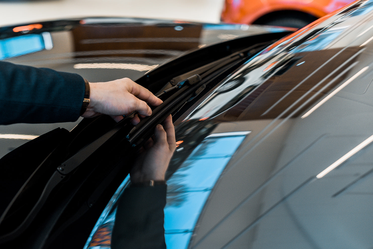 Worker adjusting front windshield blade 