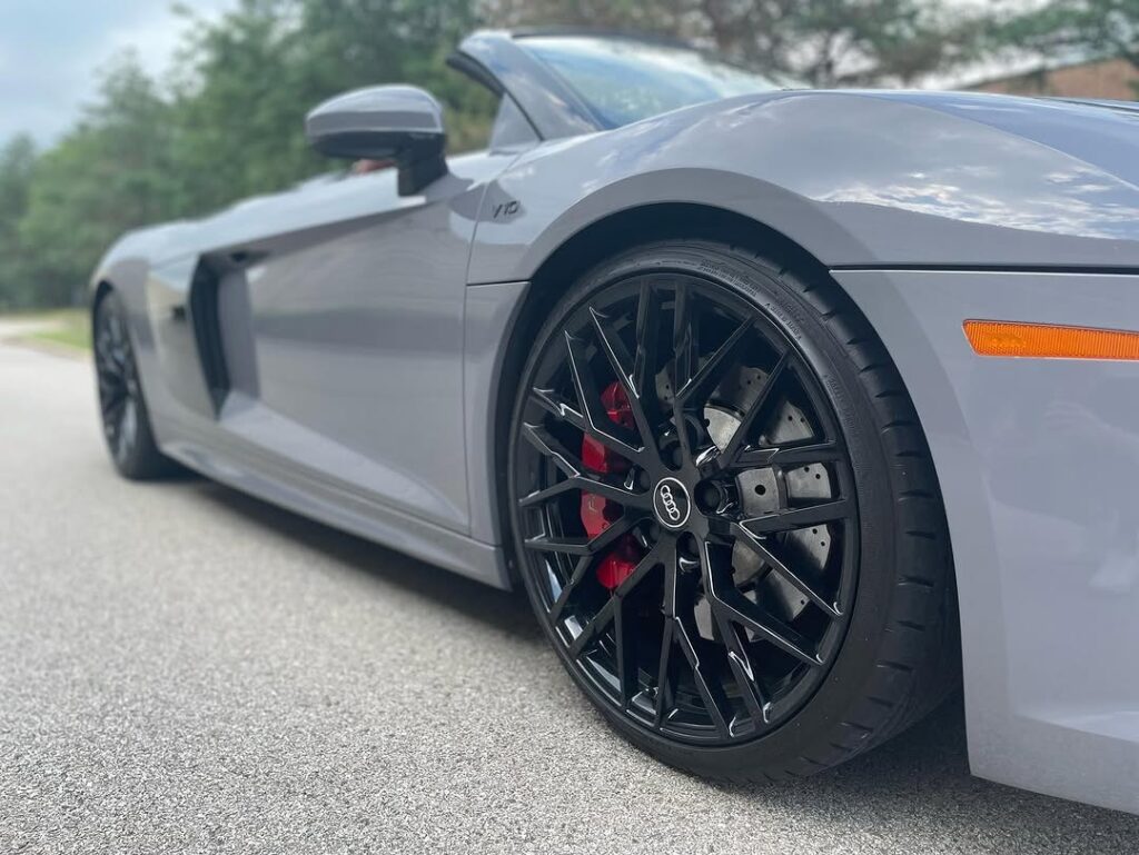 A gray sports car with black mag wheel