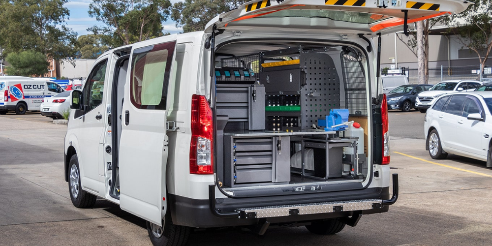 Van parked on the side of the road with back and side doors are open
