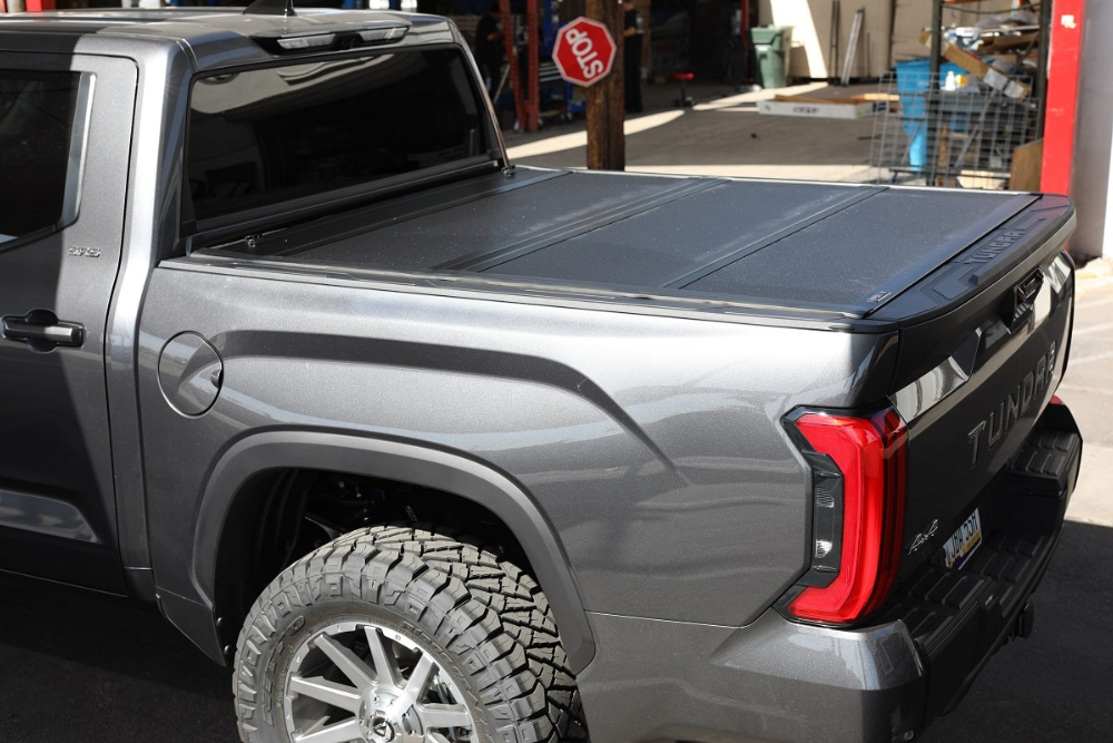 Retractable bed cover installed on gray pick up