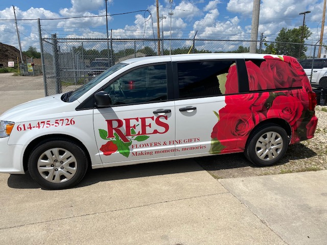 A Rees flower delivery van with vibrant flower graphics