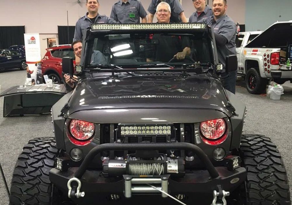 Group of people taking a picture inside a massive suv
