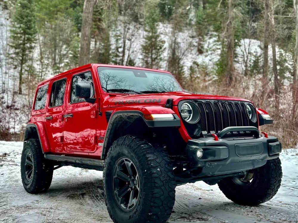Red suv parking side of the road