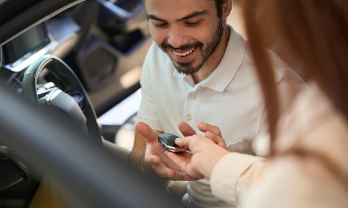 Smiling,Automotive,Buyer,Receiving,Car,Remote,Control,From,Saleswoman Smiling,Automotive,Buyer,Receiving,Car,Remote,Control,From,Saleswoman