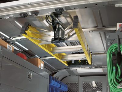The inside of a van features a ladder racks and several tools placed around, ready for use. The inside of a van features a ladder racks and several tools placed around, ready for use.
